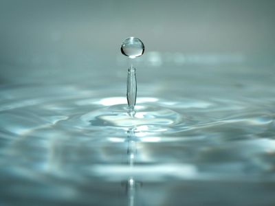 A drop of water creating ripples, symbolizing clarity.